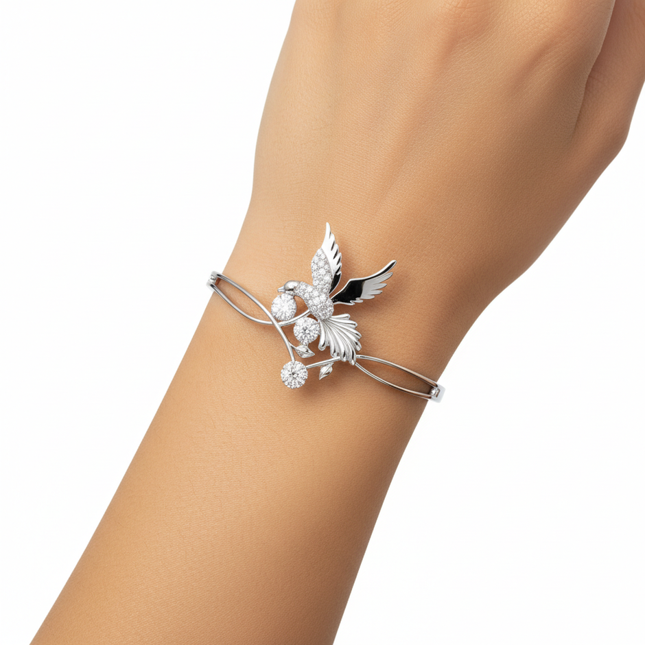 Emessa Diamond Bird & Floral Motif Bangle in 18ct White Gold worn on wrist