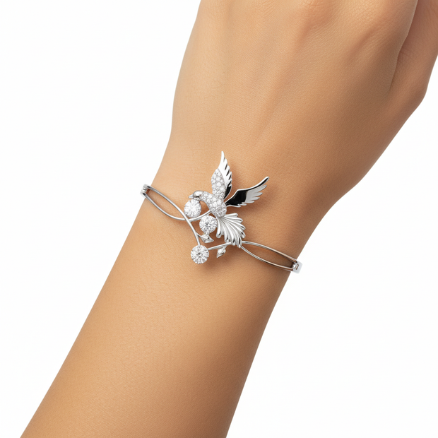 Emessa Diamond Bird & Floral Motif Bangle in 18ct White Gold worn on wrist