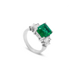 Angled view of 18ct white gold Colombian emerald ring with natural diamond surround in a timeless, elegant setting.