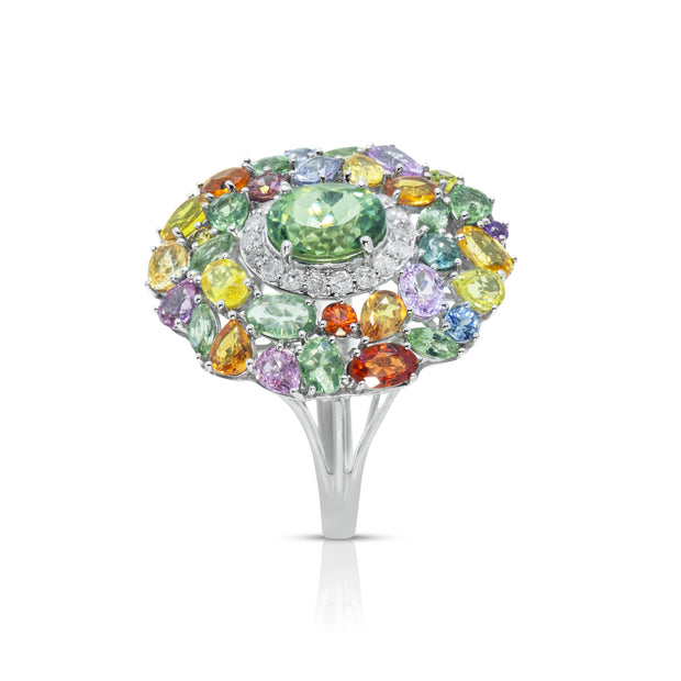 Angled view of the Emessa Aurora Garden 18ct yellow gold green tourmaline cluster ring with diamond and sapphire accents