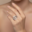 Floral diamond cluster ring worn on hand, showing the low-profile flower cluster and polished 18ct white gold band.