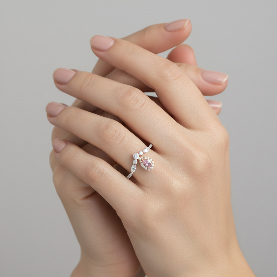Harmony Tear-Drop pear pink diamond cluster ring worn on hand, showing the two-tone setting and sparkling halo silhouette.