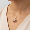 Rosé Radiance moissanite and diamond pendant worn on neck, showcasing the oval purplish-pink centre stone and sparkling diamond motif.
