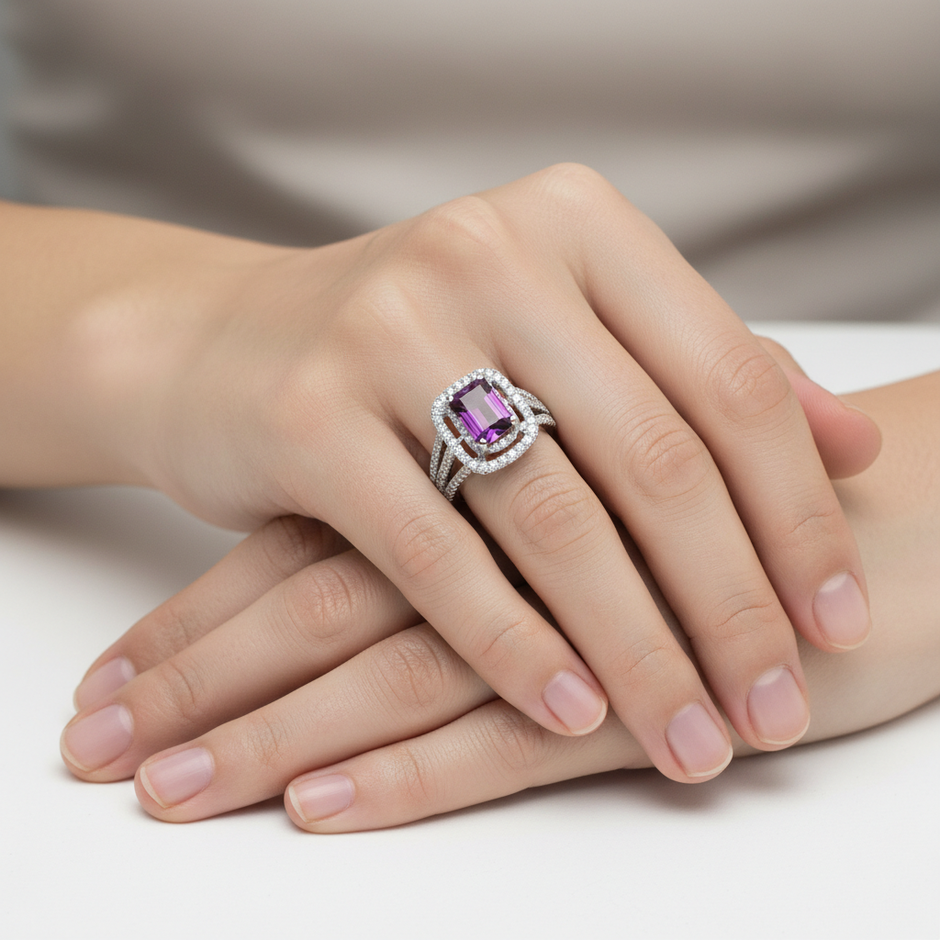 Royal Garnet Cluster ring worn on hand, showing the emerald-cut garnet centre stone and sparkling diamond surround in 18ct white gold.