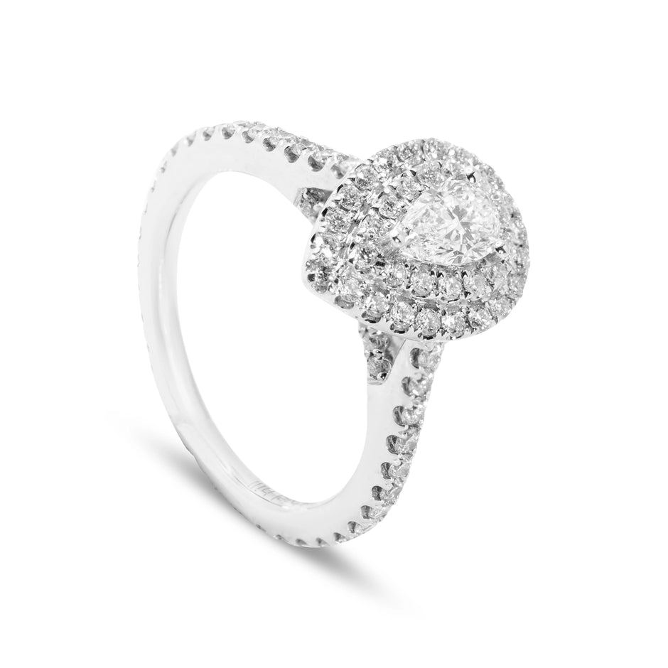 Angled view of 18ct white gold pear diamond ring with two small rubies set into the arch detail for added depth.